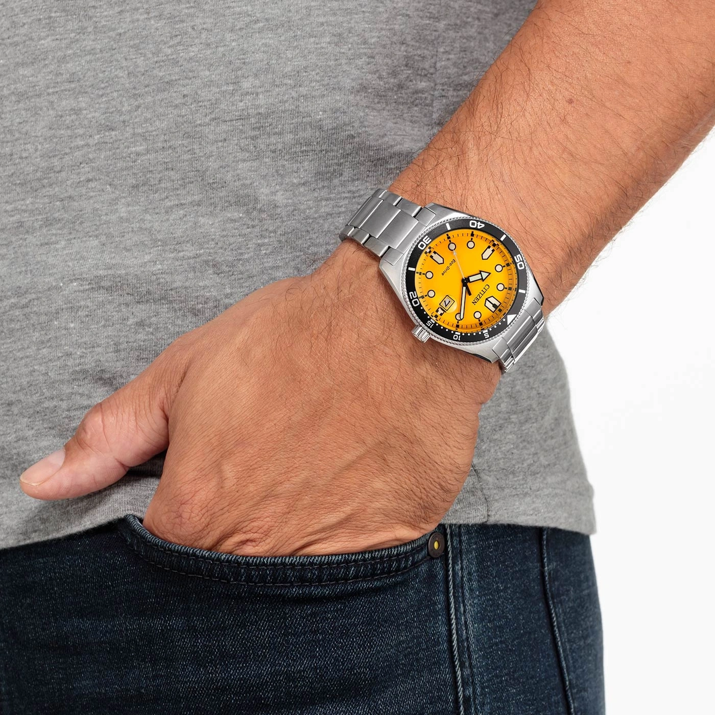 Mann trägt Citizen-Uhr mit gelbem Zifferblatt und silbernem Armband.
