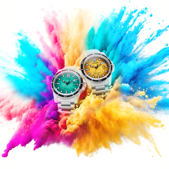 Two Citizen Eco-Drive watches, one green and one yellow, are featured against a vibrant explosion of pink, yellow, blue, and orange powder.
