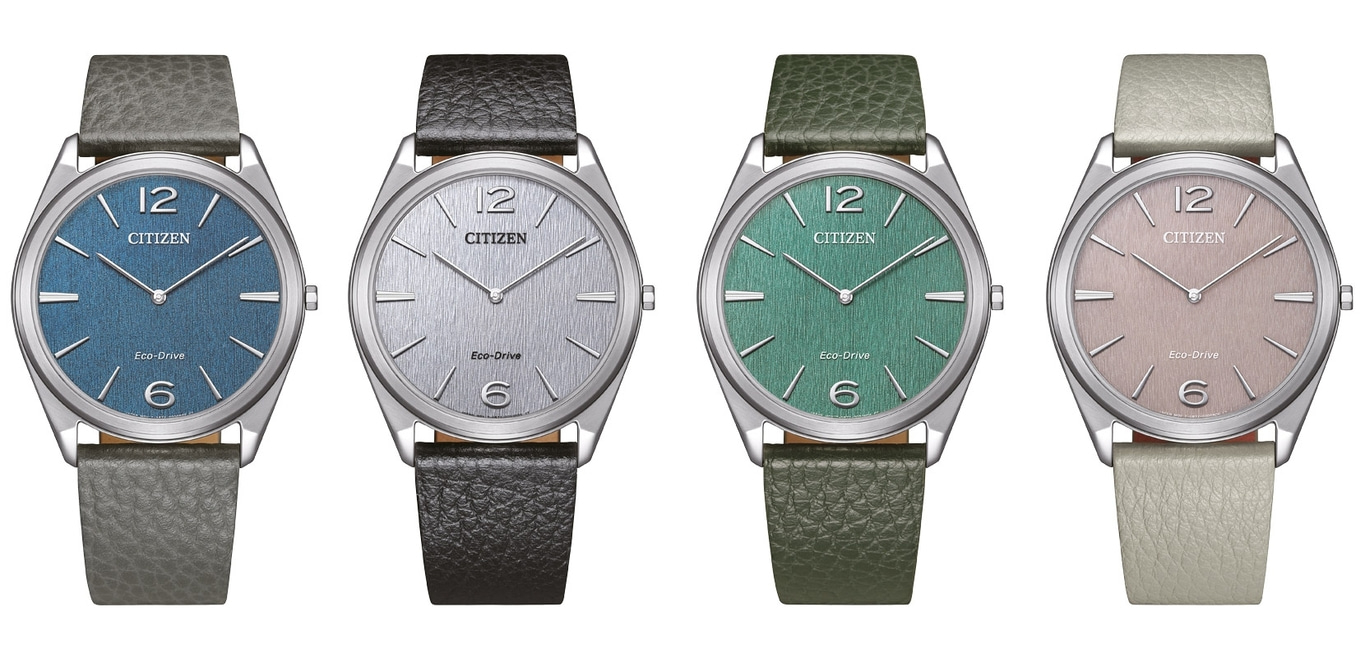 Vier Citizen-Uhren mit verschiedenfarbigen Zifferblättern und Lederarmbändern.