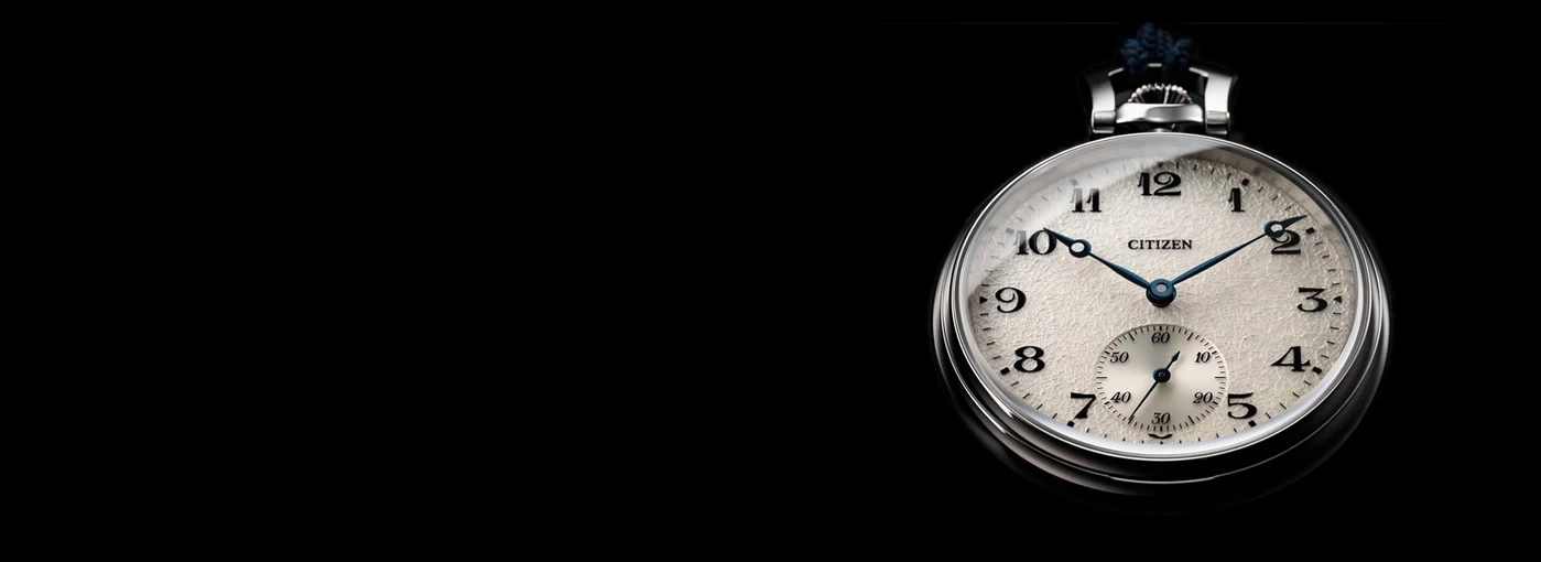 Eine Nahaufnahme einer alten Citizen-Taschenuhr auf schwarzem Hintergrund.