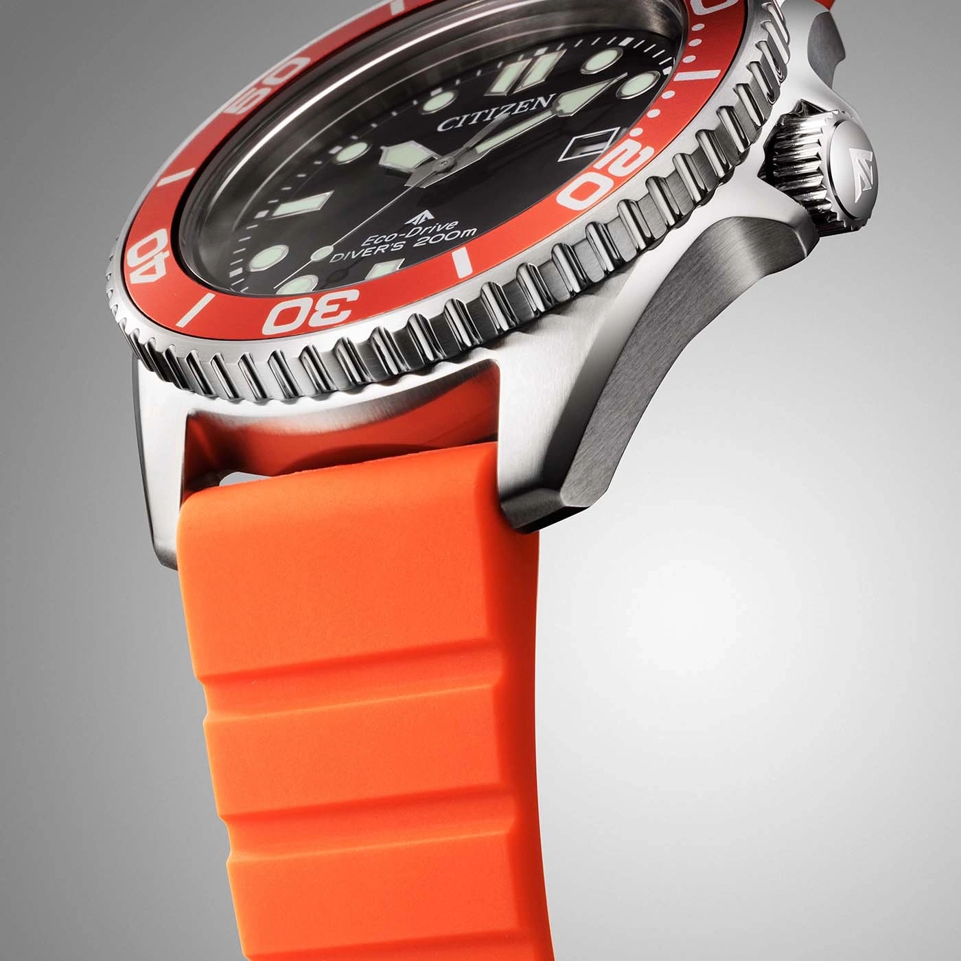 Nahaufnahme einer Citizen Eco-Drive Taucheruhr mit orangefarbenem Armband.