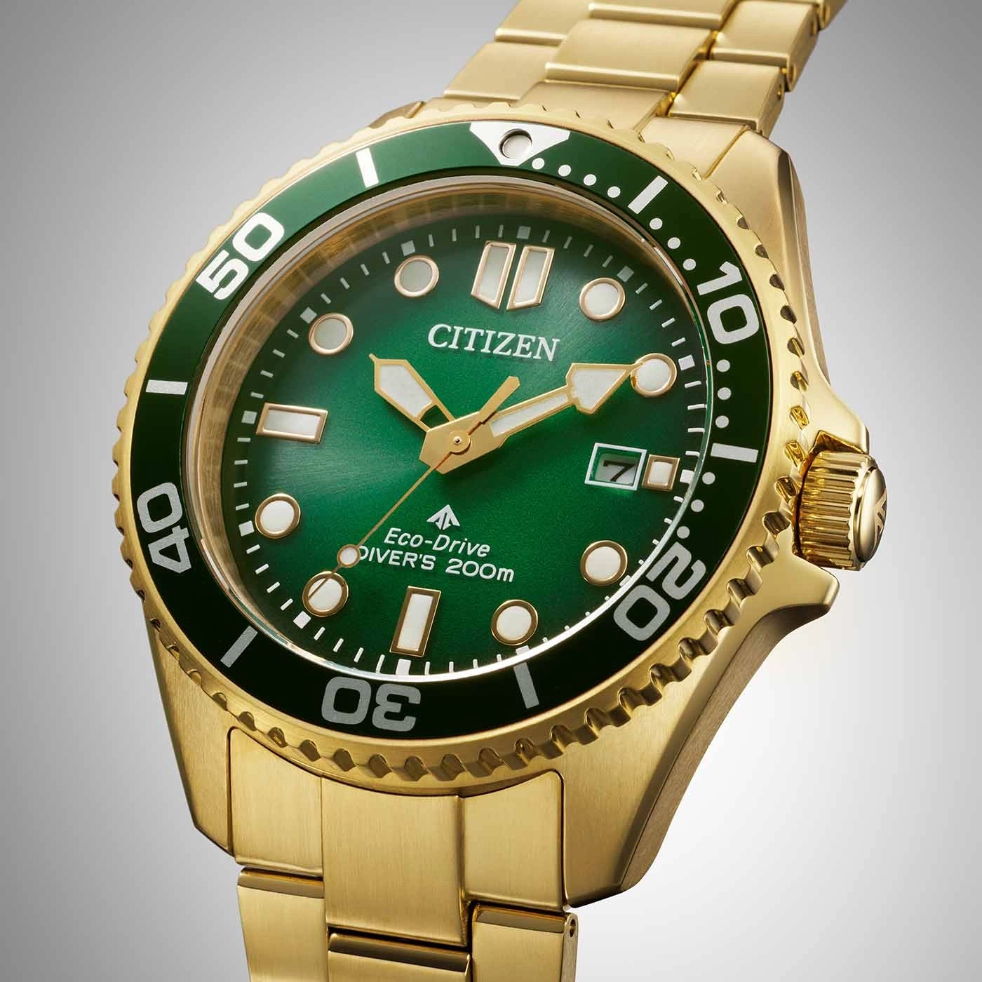 Goldene Citizen-Uhr mit grünem Zifferblatt und Lünette, Nahaufnahme.