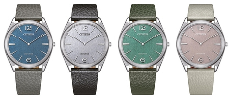 Vier Citizen-Uhren mit verschiedenfarbigen Zifferblättern und Lederarmbändern, elegantes Design.