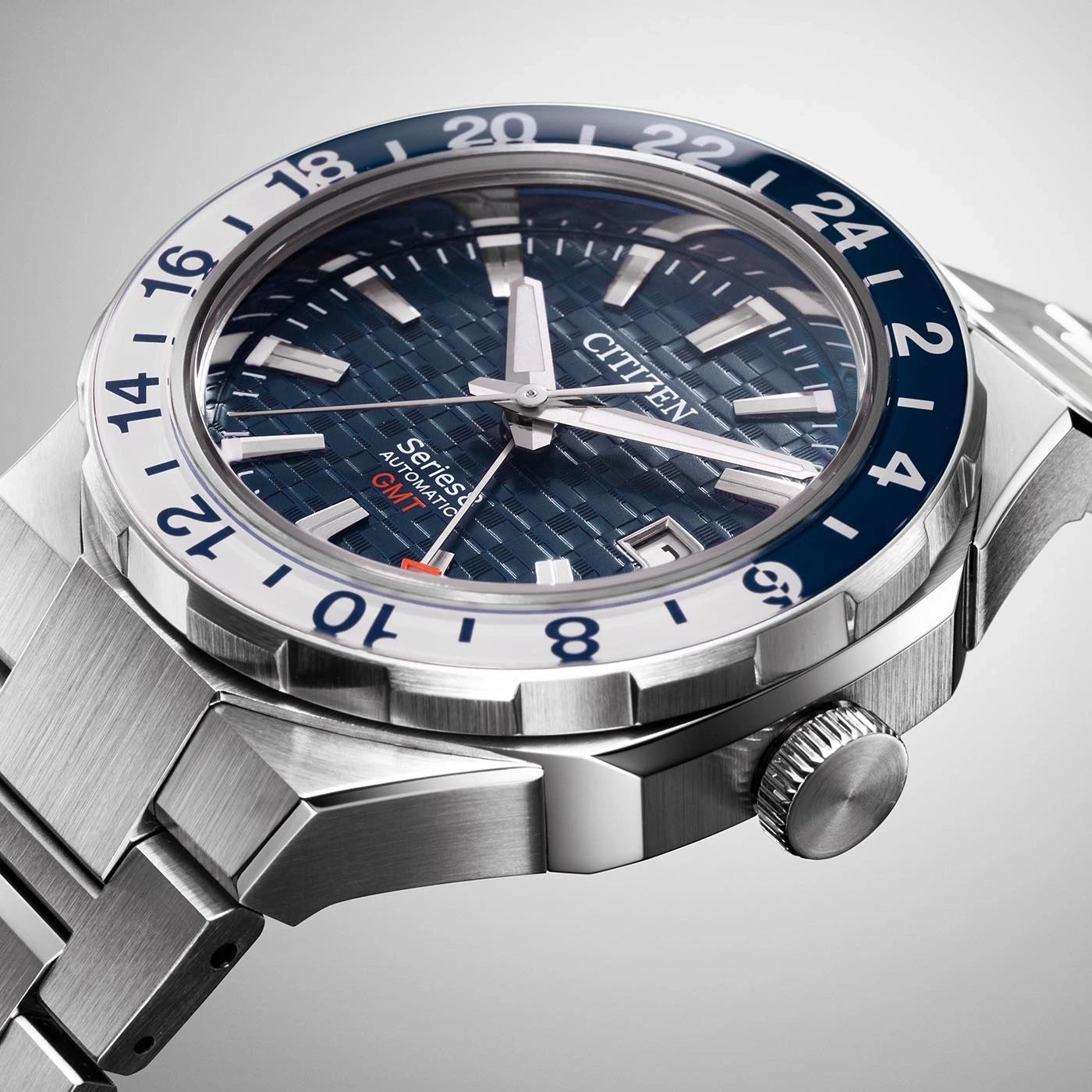 Nahaufnahme einer Citizen-Uhr mit blau-weißer Lünette und Metallarmband.