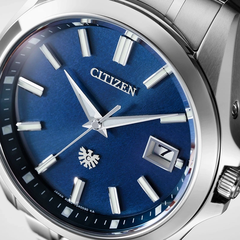 Citizen-Uhr mit blauem Zifferblatt, silbernen Zeigern und Datumsanzeige bei 3 Uhr.